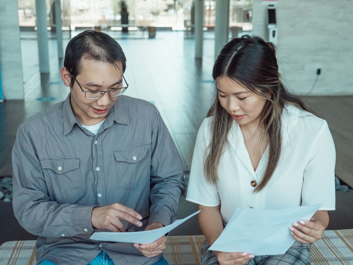 Two colleagues reviewing a translated document together at a desk
