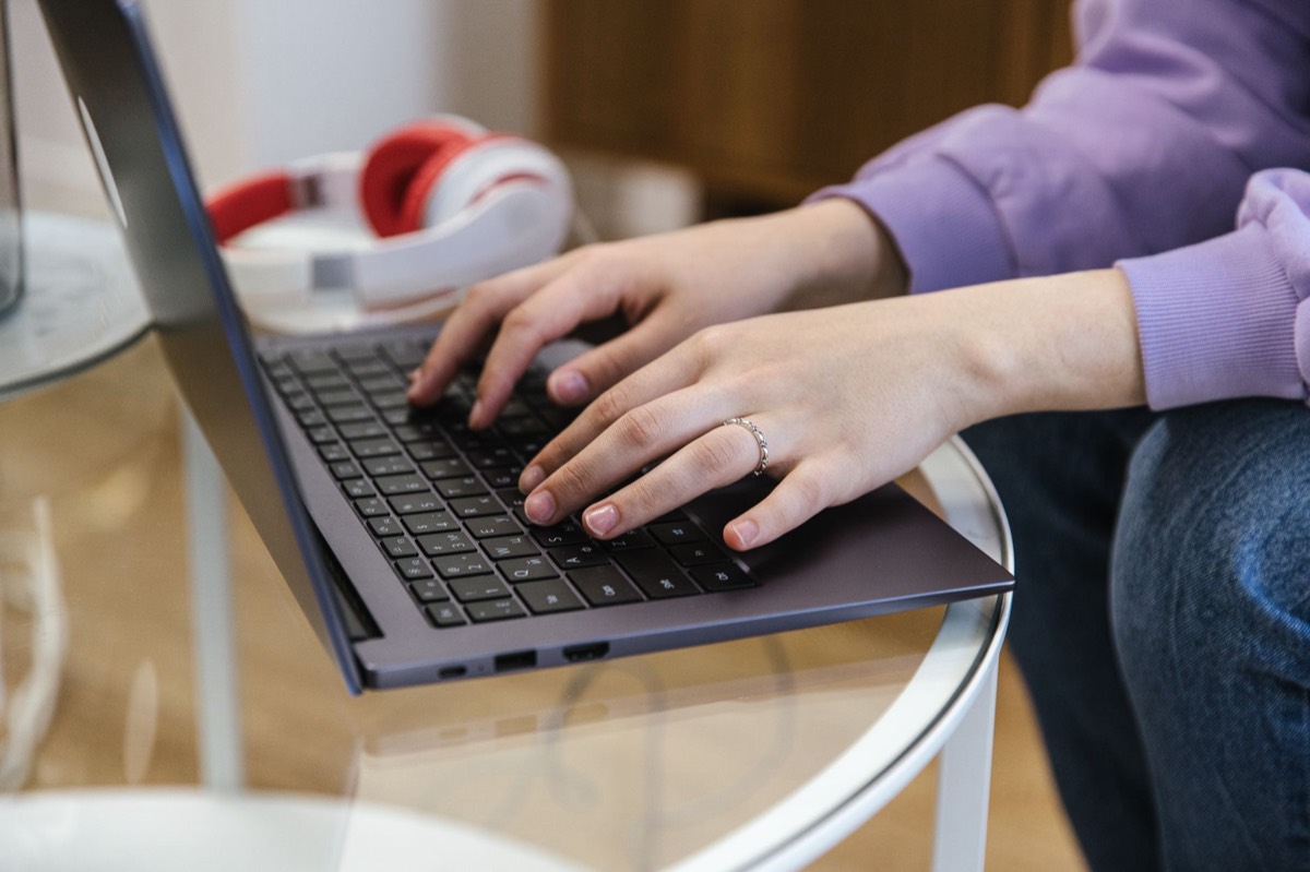 Person writing a feedback email at a laptop