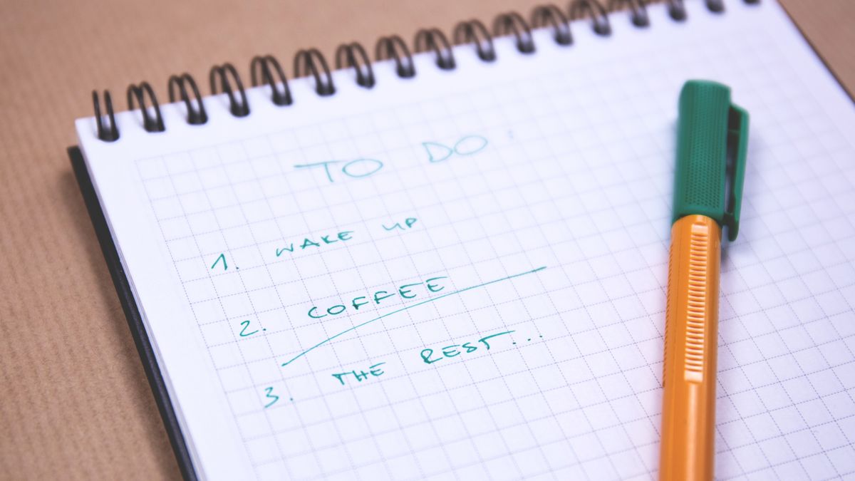 Planning notebook with a checklist and coffee cup, prepared before submitting a translation order